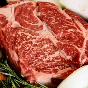 chuck roast surrounded by veggies in a cast iron pan