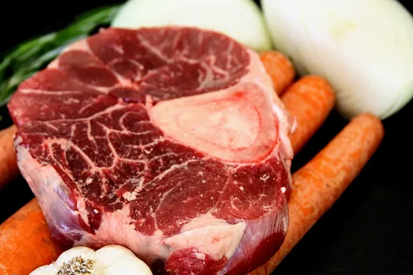 Picture of beef surrounded by vegetables