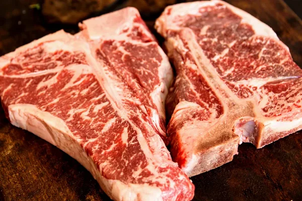 Close-up picture of T-bone steaks on a cutting board