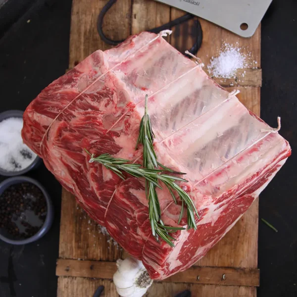 fresh bone-in prime rib on the cutting board ready for holiday celebrations