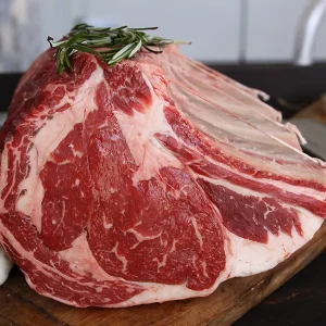 fresh bone-in prime rib on the cutting board ready for holiday celebrations